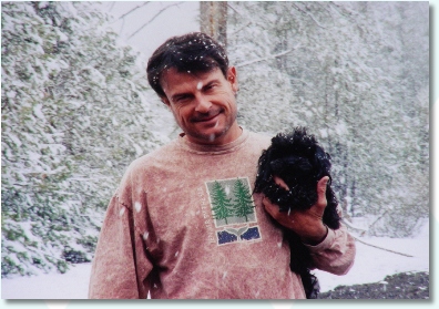 Artist Dan Blair with his dog Rudy out in the snow.